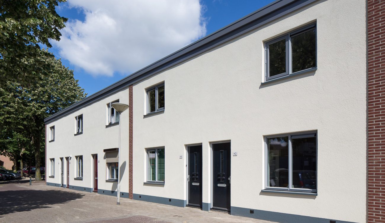 Groot onderhoud 76 woningen Vestkant Breda gerenoveerde rijwoningen met witte gevels, zwarte deuren.