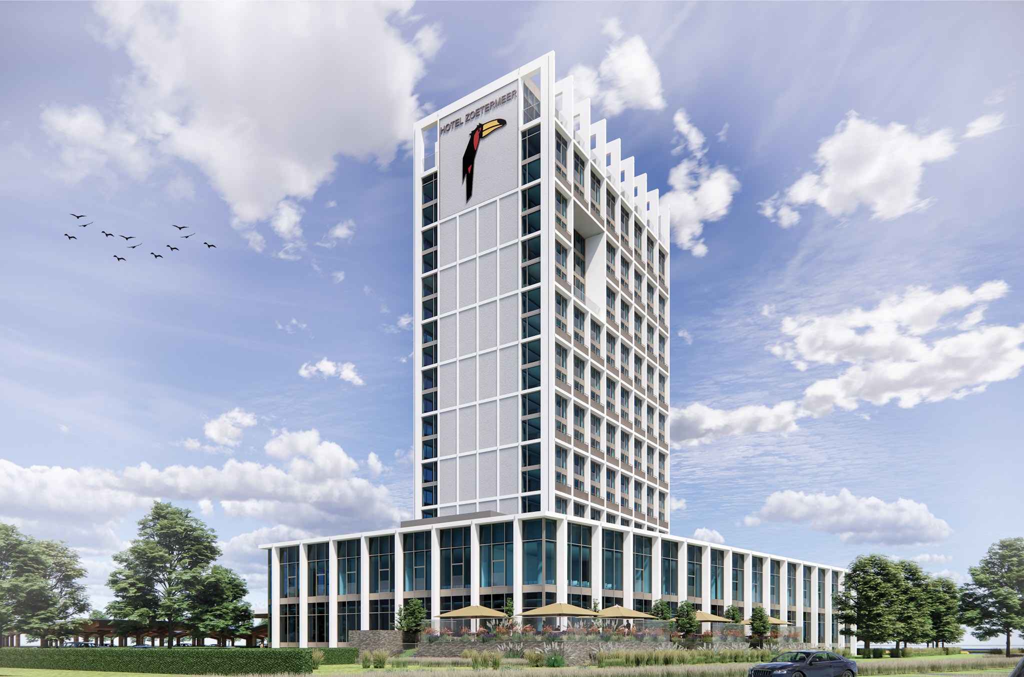 Hotel Zoetermeer met hoge toren en glazen plint omgeven door groene buitenruimte