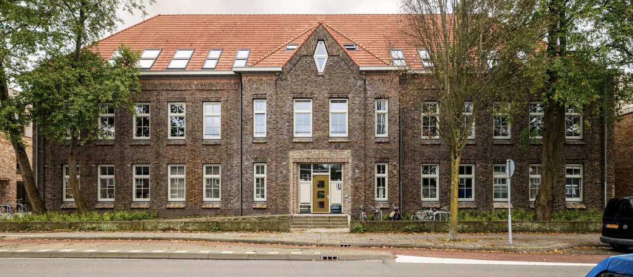 Vooraanzicht van appartementencompex, met hoofdingang in het midden