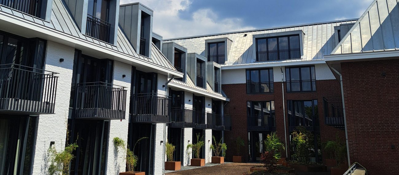 Uitbereiding en renovatie van der valk in Wassenaar. Achterzijde van het hotel met balkons en een tuin in aanleg