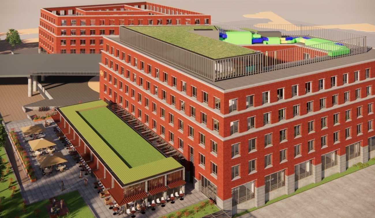 Impressie Van der Valk Maastricht-Maas met rode baksteen, dakterras en groene daken.
