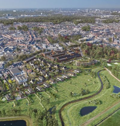 Luchtfoto van het gebied in Goirle vóór de start van het nieuwbouwproject Land van Anna, met zicht op het bestaande landschap en omliggende bebouwing.