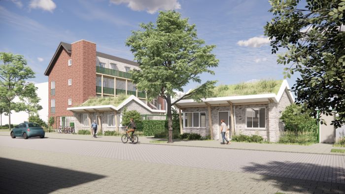 Impressie van het nieuwbouwproject Voetnoodt, met zicht op het appartementencomplex en de bungalows vanuit een andere hoek, omgeven door groen.